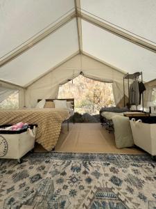 a bedroom in a tent with a bed and a rug at Vegas Glamping in Marie Camp
