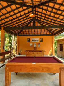 a pool table in the middle of a room at Chalés Bela Vista in Paraty