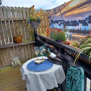 a table with two wine glasses on a balcony at Cosy Apartment in Galway with Balcony, 32 m², City View in Galway