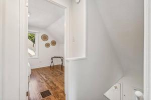 a white hallway with a table and a mirror at Heritage 3BR Etobicoke Gem, Sherway Gardens, BBQ in Toronto +56 photos
