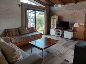 a living room with a couch and a coffee table at Las Olas in Piriápolis