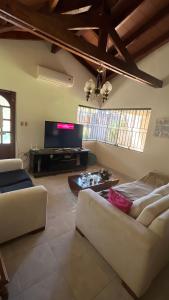 a living room with two couches and a flat screen tv at Habitacion privada en casa familiar in San Bernardino +3 photos