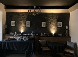 a dining room with a table and chairs and a chandelier at The Black Tree Hotel Boutique in Mazatlán