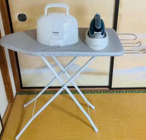 a table with two appliances sitting on top of it at Grace House グレイスハウス- Country Home Relaxation in Okawa