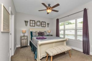 a bedroom with a bed and a ceiling fan at Owl's Nest - Cozy Townhome Close to Beaches, Attractions & More! in Fort Walton Beach