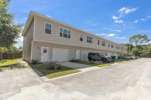 a building with a car parked in front of it at Owl's Nest - Cozy Townhome Close to Beaches, Attractions & More! in Fort Walton Beach