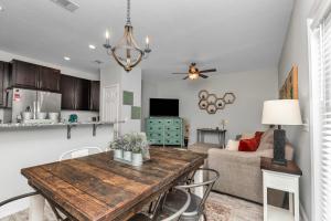a kitchen and living room with a table and a couch at Owl's Nest - Cozy Townhome Close to Beaches, Attractions & More! in Fort Walton Beach