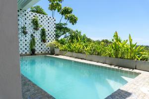 a swimming pool in front of a house at Lanna Lanta in Phra Ae beach
