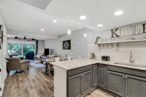 a kitchen with a sink and a living room at EZ Beach Access - 2 Bed 2 and one half Bath 23 Coligny Villa in Hilton Head Island