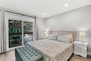 a bedroom with a bed and a large window at EZ Beach Access - 2 Bed 2 and one half Bath 23 Coligny Villa in Hilton Head Island