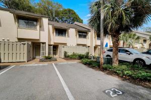 a car parked in a parking lot in front of a building at EZ Beach Access - 2 Bed 2 and one half Bath 23 Coligny Villa in Hilton Head Island