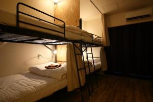 Letto o letti in una camera di Hiroei Hostel