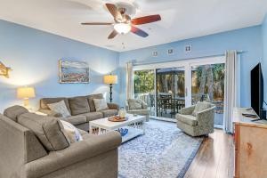 a living room with a couch and a ceiling fan at Lovely 3 Bed3 Bath Pet FriendlyVilla - Walk to the beach pools and tennis #75 Ocean Breeze in Hilton Head Island