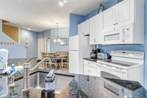 a kitchen with white appliances and a dining room at Lovely 3 Bed3 Bath Pet FriendlyVilla - Walk to the beach pools and tennis #75 Ocean Breeze in Hilton Head Island