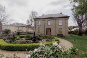 a large house with a fountain in a garden at 'Fifteen' - Heritage Terrace in Battery Point in Hobart