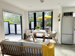 a living room with a couch and a table at Omaha Beach Private Retreat in Omaha