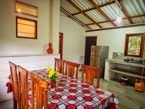a dining room with a table and a refrigerator at Per villa in Unawatuna