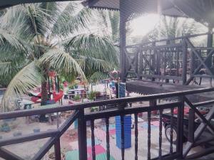 a view of a playground with palm trees at RUMAH KAYU ED BEACH Cafe in Kuala Kedah