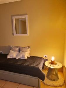 a bedroom with a bed with a candle on a table at Apartamento Catamarca in San Fernando del Valle de Catamarca +4 photos