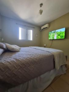 a bedroom with a bed and a tv on the wall at Apartamento Catamarca in San Fernando del Valle de Catamarca