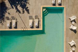 an overhead view of a swimming pool with chairs and a table at Costa Avithos in Svoronata