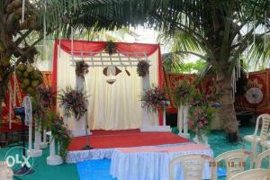a room with a stage with a table with flowers at Charisma Homestay in Mangalore