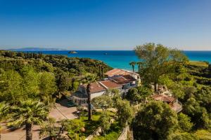 an aerial view of a house with the ocean in the background at Costa Avithos in Svoronata
