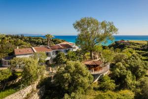 an aerial view of a house with the ocean in the background at Costa Avithos in Svoronata