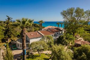 an aerial view of a house with the ocean in the background at Costa Avithos in Svoronata