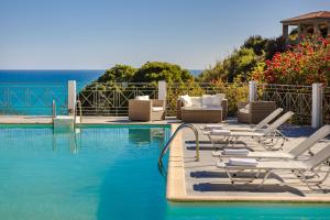 a pool with chaise lounge chairs and a swimming pool at Costa Avithos in Svoronata