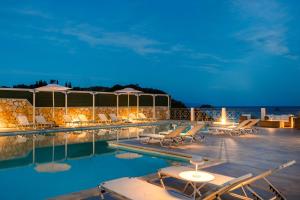 a swimming pool with lounge chairs and a resort at Costa Avithos in Svoronata