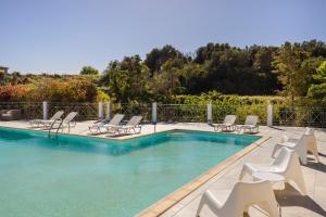 a swimming pool with chaise lounge chairs and a swimming pool at Costa Avithos in Svoronata