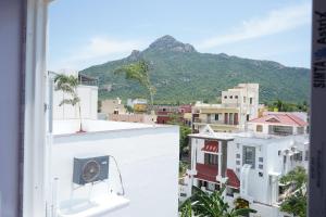 a view of a city with a mountain in the background at Golden Dawn Residency in Tiruvannāmalai