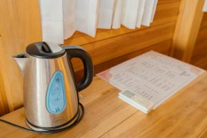 a tea kettle sitting on a table with a thermometer at The Somayan Bungalows in Nusa Penida