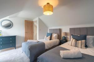 a bedroom with two beds and a blue dresser at Griffin's Rest - Parking, Countryside views in Newquay