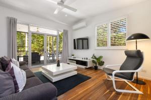 a living room with a couch and a table at Lane by the Bay - Centrally located 2 bed modern Townhouse in Byron Bay