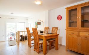 a dining room with a wooden table and chairs at Ormos Sea View Apartment in Agios Nikolaos