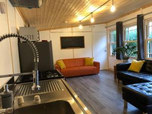 a kitchen and living room with a stove and a couch at Gorgeous Wolds Hideaway in Belchford