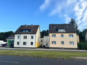 two buildings on the side of a street at AlWi Apartment Braunschweig in Braunschweig