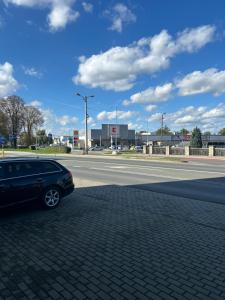a black car parked on the side of a road at Apartament Magdalenka in Strzelce Opolskie