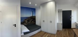 a bedroom with a bed and a view of the ocean at Apartament Magdalenka in Strzelce Opolskie