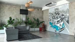 a living room with a couch and a painting of a bus at Greenlast Hotel in Kuantan