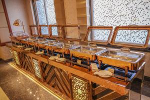 a row of sinks in a room at Hotel SS Grand in Kānpur