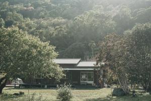 a small house in front of a mountain at Dew&Plum 白露梅室 in Ruisui