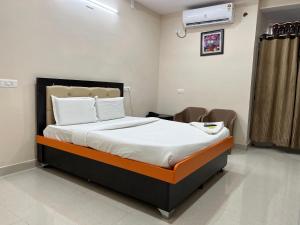 a bedroom with a large bed in a room at Hotel 5 star grand in Shamshabad +9 photos