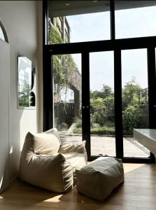 a living room with a couch and a large window at Blik Stille Hyochang 101 Yongsan Premium House in Seoul