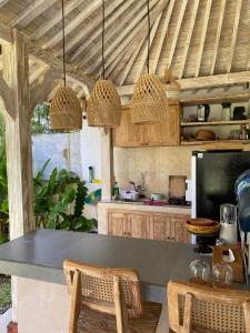 a kitchen with a table and two chairs at D'Pondok Sangaji Ricefield View by EPS in Penginyahan
