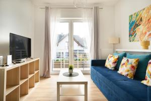 Televízia a/alebo spoločenská miestnosť v ubytovaní APARTAMENTY "LA VILLA" SUPERIOR II z dwoma sypialniami, balkonem, parkingiem, blisko centrum