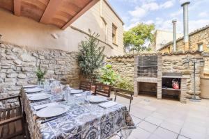 a table in a patio with a fireplace at Cal Comorera in Masoteras