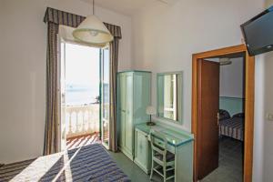 a room with a bedroom with a view of the ocean at Hotel Baia in Monterosso al Mare